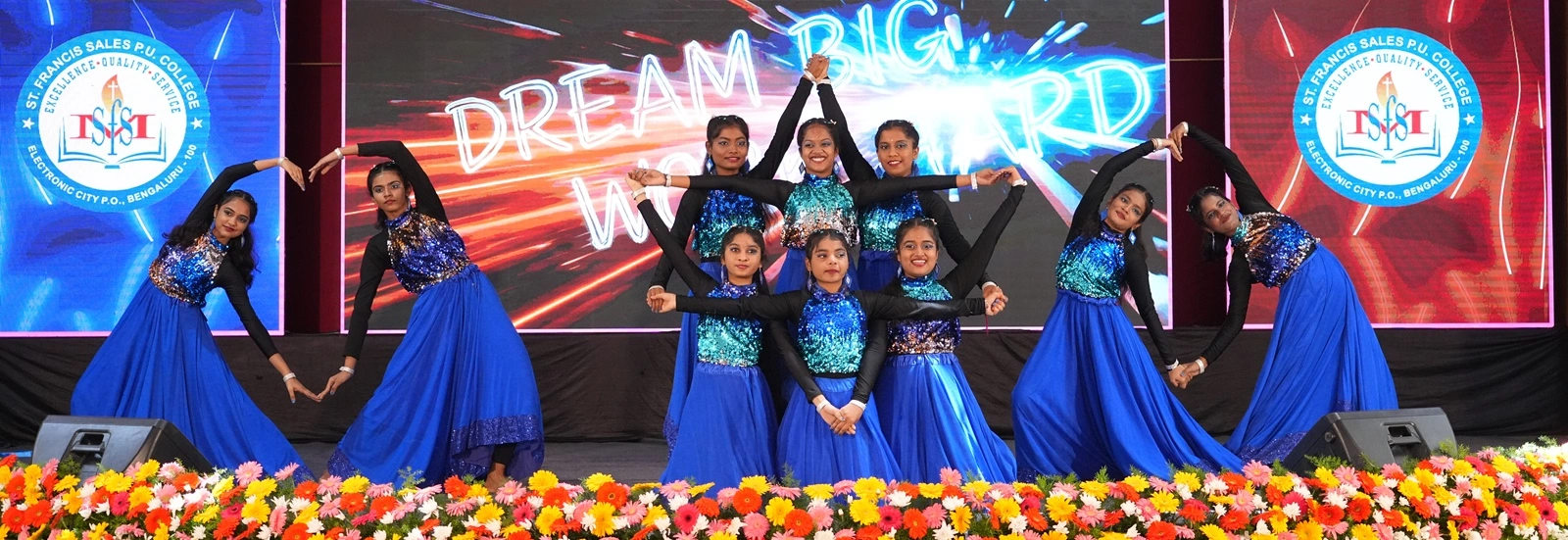 Students performing on the college auditorium stage