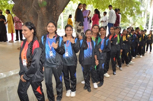 Students in college sports uniform lined up during a college sports event